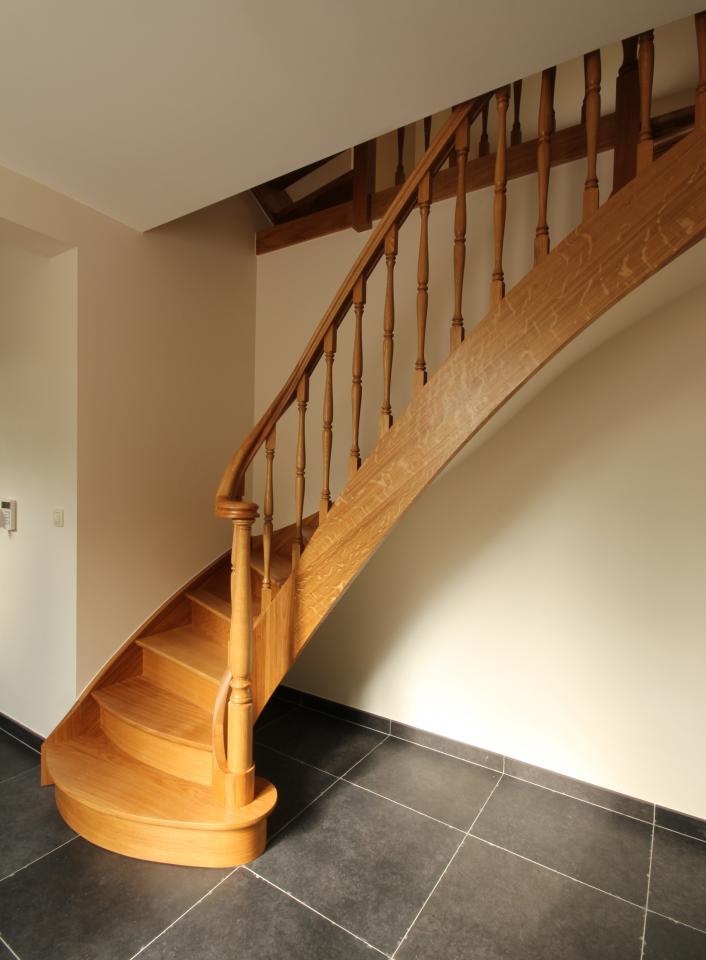 escalier quart tournant classique à contres-marches avec noyau évidé en bois sur mesure. colonnes et fuseaux tournés en bois. marche départ débordante.