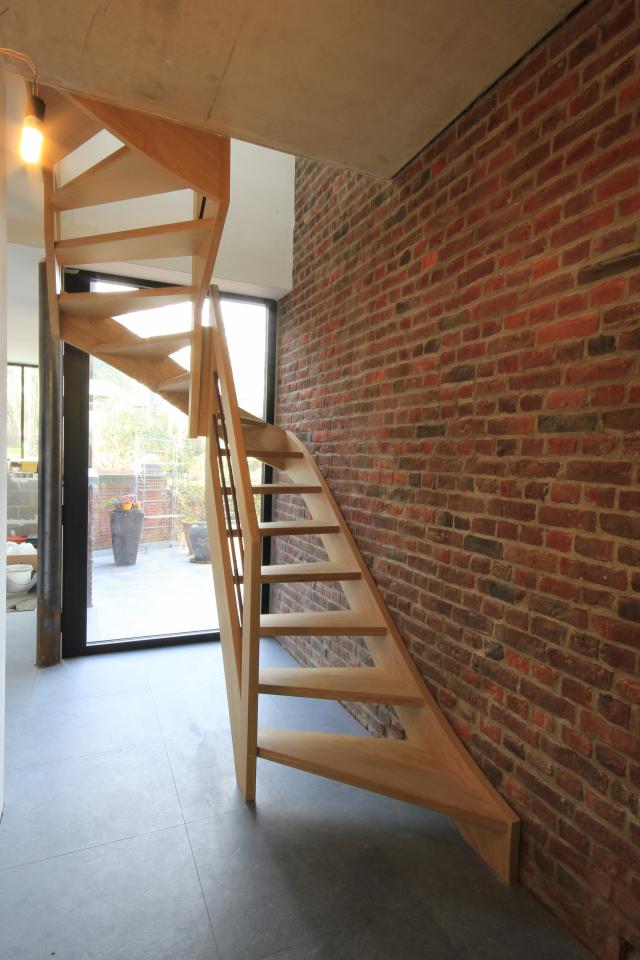escalier balancé contemporain en forme de S belgique. escalier deux quarts tournant, à claire voie. main courante rectangulaire et barres intermédiaires en acier rouillé